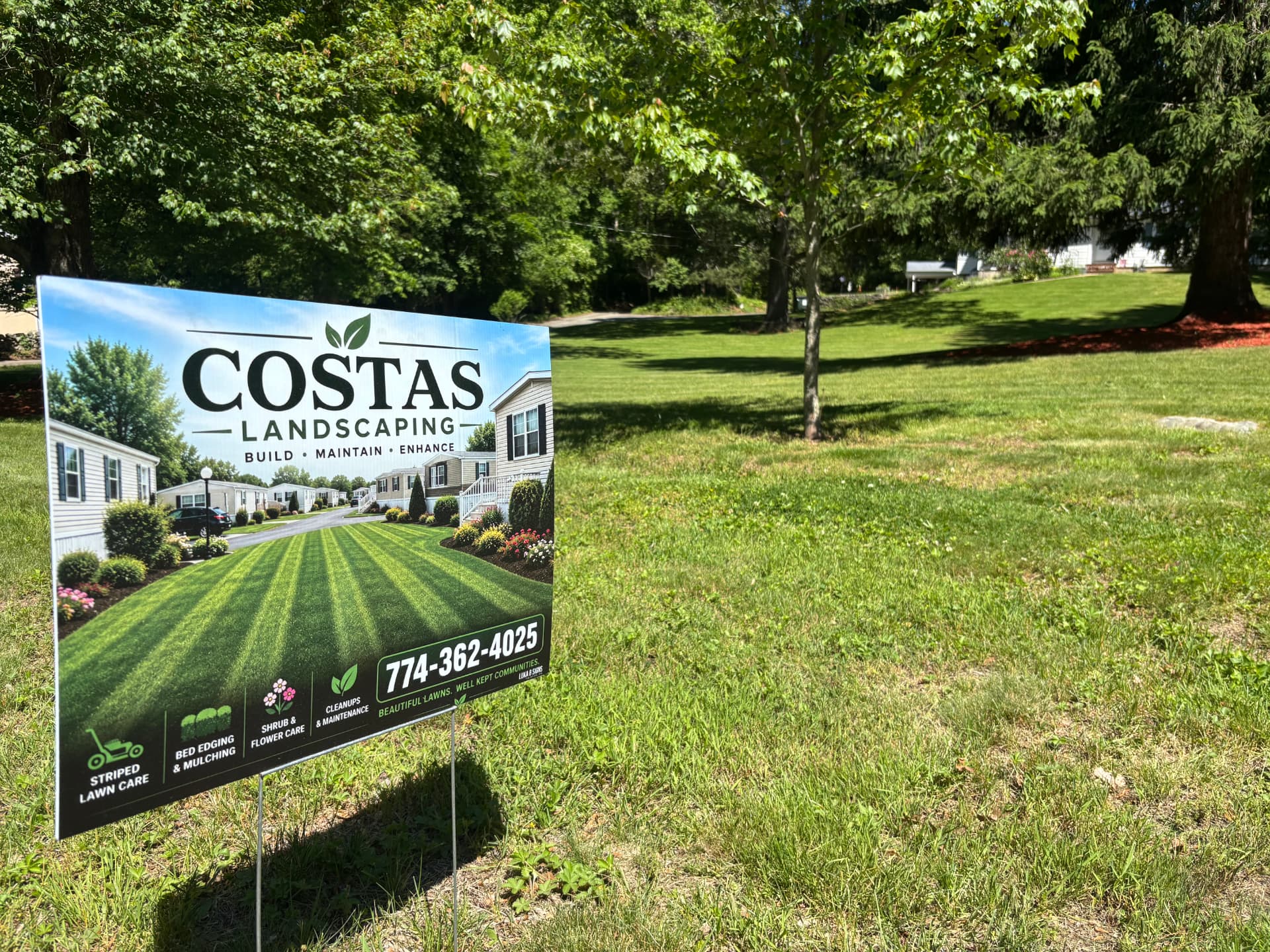 Costas Landscaping yard sign on a maintained lawn