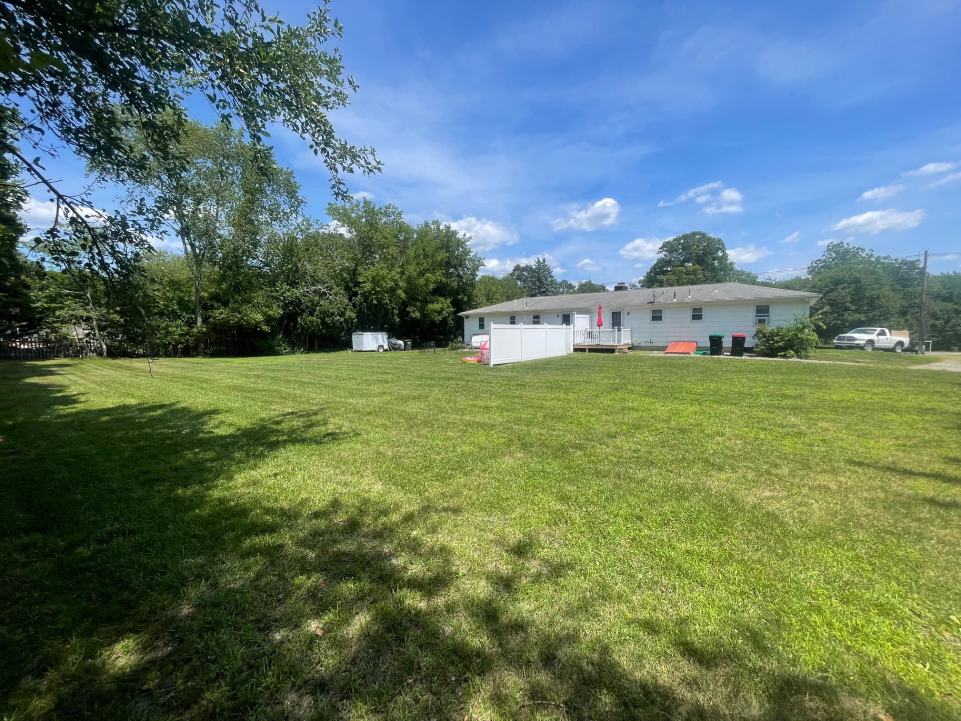 Freshly cut backyard behind a ranch home